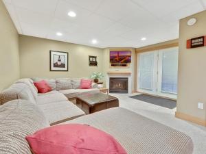 a living room with a couch and a fireplace at 689 Disciples Village Unit in Boyne Falls