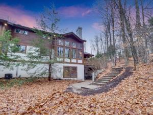 a large house with a bunch of leaves in front of it at 689 Disciples Village Unit in Boyne Falls