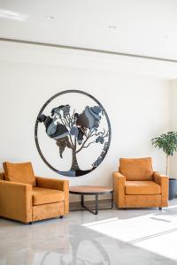 a room with two chairs and a globe on the wall at Lardos Bay Hotel in Lartos