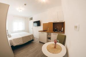 a small room with a bed and a table in it at Elegant Studio Apartments Lasta in Mostar