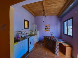a kitchen with a sink and a stove top oven at Gran Casa Hostel&Camping in Tilcara