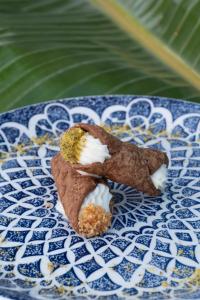 a chocolate dessert on a blue and white plate at Infinity Resort Tropea in Parghelia