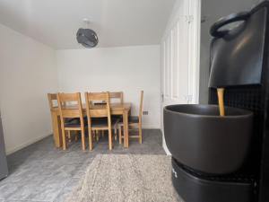 a living room with a table and a stove at North Colchester Homestay in Mile End