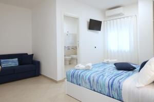 a bedroom with a bed and a blue couch at A casa di Angela B&B in Praia a Mare