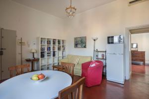 a kitchen and living room with a table and a refrigerator at Apartment with terrace facing Duomo in Florence