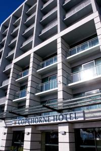 a building with a sign on the front of it at Copthorne Hotel Wellington, Oriental Bay in Wellington