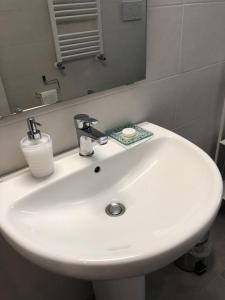 a white sink in a bathroom with a mirror at Casa CEREUS in Modugno