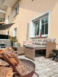 a patio with a couch and tables and a window at Panorama-Refugium in Bad Koetzting