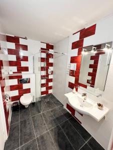 a bathroom with a sink and a toilet and a mirror at Les Chambres du Diu Biban in Hossegor +26 photos