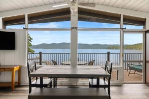 - une salle à manger avec une table et une vue sur l'eau dans l'établissement Sun Castle Resort, à Lake George