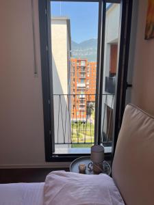 a room with a bed and a large window at Zirkon City Rush Apartment in Tirana