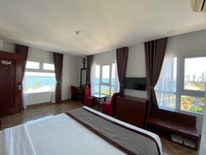 a hotel room with a bed and a view of the ocean at Gem Nha Trang Hotel in Nha Trang