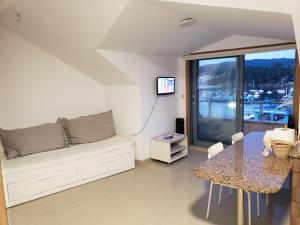 a living room with a couch and a table at ÁTICO SANXENXO CON TERRAZAS Y VISTAS AL MAR in Sanxenxo