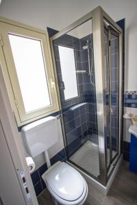 a bathroom with a toilet and a shower at Venustas in Lampedusa