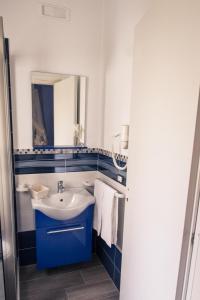 a bathroom with a sink and a mirror at Venustas in Lampedusa