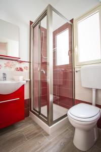 a bathroom with a shower and a toilet and a sink at Venustas in Lampedusa