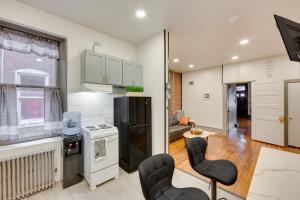a kitchen with white appliances and a living room at Harrisburg Hideaway with Yard about 2 Mi to Downtown in Harrisburg