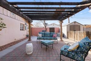 a patio with couches and chairs on a brick patio at Loma Linda Courtyard Suites in Phoenix