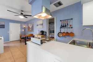 a kitchen with blue walls and a counter top at Loma Linda Courtyard Suites in Phoenix