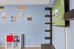 a room with a blue wall with a staircase at Loma Linda Courtyard Suites in Phoenix