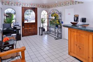 a restaurant with a kitchen with a counter and a door at Americas Best Value Inn Loma Lodge in San Diego