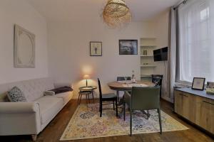 a living room with a couch and a table at Les Mots Bleus in Dinard