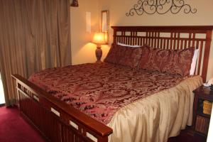 a bedroom with a large bed with a red comforter at Oak Square 201 in Gatlinburg +21 photos