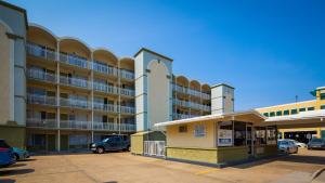 a parking lot in front of a large building at SureStay Hotel by Best Western Virginia Beach Royal Clipper in Virginia Beach