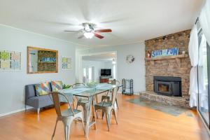 a dining room with a table and a fireplace at Rogers Vacation Rental about 7 Mi to Downtown in Rogers