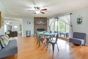 a dining room and living room with a table and chairs at Rogers Vacation Rental about 7 Mi to Downtown in Rogers
