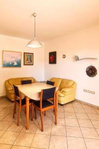 a living room with a table and a couch at Le Cave Apartment in Sirolo