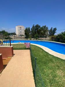 a large swimming pool with a fence around it at A&C Vistas al mar -Torre del mar - Malaga in Vélez-Málaga