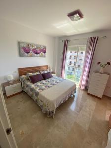 a bedroom with a bed and a large window at Vistas al mar -Torre del mar- HOME RENT MALAGA in Vélez-Málaga +37 photos