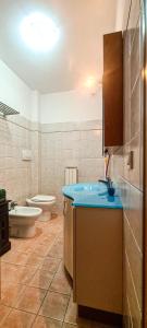 a bathroom with a sink and a toilet at Le Cave Apartment in Sirolo