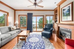 a living room with a couch and a fireplace at Sun Castle Resort in Lake George