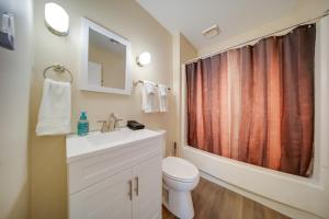 a bathroom with a toilet and a sink and a shower at Ashtabula Vacation Rental with Covered Balcony in Ashtabula