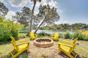 a group of yellow chairs around a fire pit at Crystal River Retreat with Private Dock and Kayaks! in Crystal River