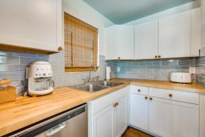 a kitchen with white cabinets and a sink at Crystal River Retreat with Private Dock and Kayaks! in Crystal River
