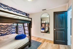 a bedroom with a bunk bed and a mirror at Crystal River Retreat with Private Dock and Kayaks! in Crystal River