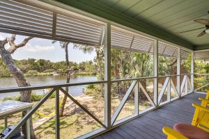 a screened in porch with a view of the river at Crystal River Retreat with Private Dock and Kayaks! in Crystal River