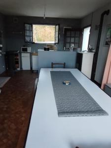 a kitchen with a table with a ring on it at Maison indépendante à proximité des lacs in Saint-Pierre-Bellevue