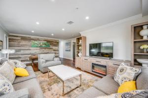 a living room with a couch and a tv at Everglades City Apt Near Marina and National Park! in Everglades City