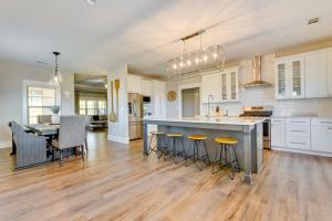 a large kitchen with a large island and a table at Russellville Home Near Hiking and Lake Access! in Russellville