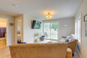 a living room with a couch and a tv at Port Clinton Vacation Rental with Boat Dock and Grill! in Port Clinton