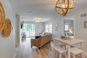 a living room with a table and a couch at Port Clinton Vacation Rental with Boat Dock and Grill! in Port Clinton