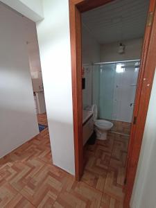 a bathroom with a toilet and a shower in it at Aluguel de suites e Apartamento in Itacaré