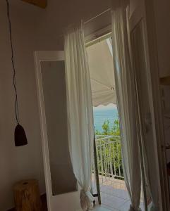 a room with a window with a view of the ocean at MarKaMar in Loutraki
