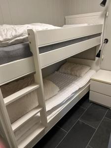 a white bunk bed with two pillows on it at Leilighet i Tråstølen Bavallen Voss in Skulestadmo +16 photos