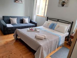 a bedroom with a bed and a couch at Studio Sofia Campiello in Corfu Town
