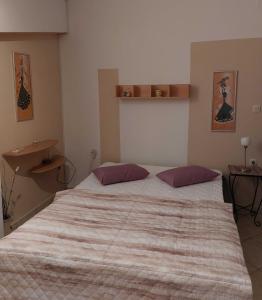 a bedroom with a large bed with two pillows at Apartment Rama in Poreč